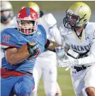  ?? [PHOTO BY NATE BILLINGS, THE OKLAHOMAN] ?? John Marshall’s Devonte Lee carries the ball earlier in the playoffs.