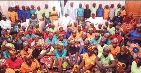  ??  ?? Freed Chibok girls with President Muhammadu Buhari (centre), his Chief of Staff, Abba Kyari, and Minister of Informatio­n, Lai Mohammed