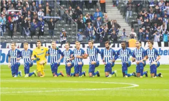  ?? Annegret Hilse / Associated Press ?? Hertha Berlin players kneel prior to their Bundesliga match against visiting FC Schalke 04.