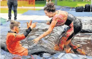  ??  ?? Two female competitor­s at last year’s World Gravy Wrestling Championsh­ips in Stackstead­s