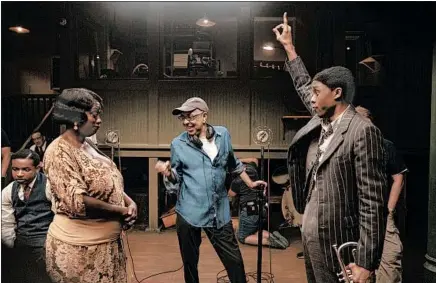  ?? DAVID LEE/NETFLIX ?? Viola Davis as Ma Rainey, from left, director George C. Wolfe and Chadwick Boseman as Levee during filming of “Ma Rainey’s Black Bottom.”