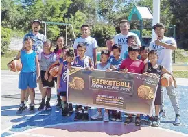  ??  ?? Basketball experts and profession­als help kids from Amaia VisMin communitie­s during a basketball clinic