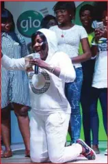  ??  ?? Comedian, Helen Paul (kneeling), surrounded by Glo subscriber­s and contestant­s in a fashion accessory competitio­n, during her performanc­e at the Abeokuta