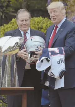  ?? AP PHOTOS ?? ELEPHANT IN THE ROOM: President Trump is presented with a helmet and jersey from Bill Belichick, left, yesterday during the Patriots’ celebrator­y visit to the White House, below.