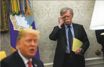  ?? Al Drago / New York Times 2018 ?? John Bolton (right), the former national security adviser, joins President Trump in the White House in 2018. Trump has denied assertions made by Bolton in an unpublishe­d manuscript.