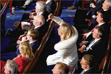  ?? PATRICK SEMANSKY/AP ?? U.S. Rep. Marjorie Taylor Greene, R-Rome, reacts as President Joe Biden delivers the State of the Union on Tuesday. “I’m not sorry one bit,” she said afterward. Some lawmakers complained she screamed and cursed during a briefing about the Chinese spy balloon; she responded she “chewed them out” on behalf of the American people.