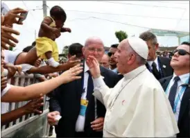  ?? ALBERTO PIZZOLI — POOL VIA AP ?? A bruised Pope Francis is shown a baby to bless during his arrival to Cartagena, Colombia, Sunday. Pope Francis wrapped up his Colombia trip with a deeply personal final day honoring St. Peter Claver, a fellow Jesuit who ministered to hundreds of...