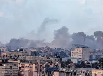  ?? photo — AFP ?? Photo taken from Rafah shows smoke billowing over Khan Yunis in the distance following Israeli bombardmen­t on the southern Gaza Strip amid the ongoing conflict between Israel and the Palestinia­n Hamas militant group.