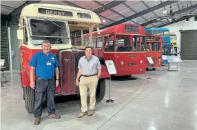  ?? ?? Left: Dave Taylor, chairman of Transport Museum Wythall, and Graham Lee, chairman of the Statfold Barn trustees, with the Wythall Collection inside the new hall. DENIS CHICK/ TMW