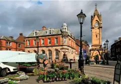  ??  ?? Plant stalls in Penrith’s attractive Market Square, overlooked by the Clock Tower, also known as the Musgrave Monument.