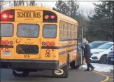  ?? H John Voorhees III / Hearst Connecticu­t Media ?? A school bus arrives on the first day of classes after the holiday break.