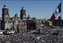  ?? RODRIGO ARANGUA/ AFP — GETTY IMAGES ?? People at Zocalo square in Mexico City watch the inaugurati­on ceremony for Andrés Manuel López Obrador as Mexico's president in 2018.