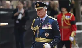  ?? KATE GREEN — POOL PHOTO VIA THE ASSOCIATED PRESS ?? Britain’s King Charles III walks behind the coffin during the procession for Queen Elizabeth II, in London on Wednesday. The Queen will lie in state in Westminste­r Hall for four full days before her funeral on Monday.