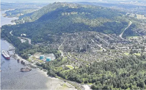  ?? JONATHAN HAYWARD/THE CANADIAN PRESS ?? An aerial view of Kinder Morgan’s Trans Mountain marine terminal, bottom left, and tank farm, upper right, in Burnaby is seen Tuesday as the federal government announced plans to buy Trans Mountain and all of Kinder Morgan Canada’s core assets.