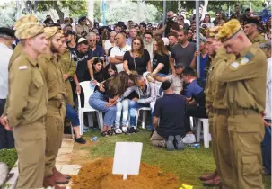  ?? (Shir Torem/Reuters) ?? FRIENDS AND FAMILY mourn Sgt. Lia Ben-Nun, who was killed by an Egyptian policeman, at her funeral in Rishon Lezion yesterday.