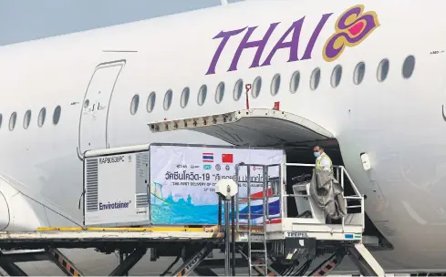  ??  ?? Here at last
A container with the first 200,000 doses of Covid-19 vaccine from China is unloaded from a Thai Airways Internatio­nal plane at Suvarnabhu­mi airport yesterday morning. SOMCHAI POOMLARD