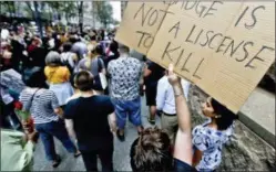  ?? KEITH SRAKOCIC - THE ASSOCIATED PRESS ?? Protestors rally in front of the Allegheny County Courthouse on Thursday, in Pittsburgh. They are protesting the killing of Antwon Rose Jr. who was fatally shot by a police officer seconds after he fled a traffic stop late Tuesday, in the suburb of...