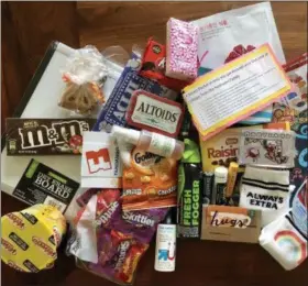  ?? MIA WALSH VIA AP ?? This September 2018 photo provided by Mia Walsh shows items that were packed into care packages at the Baltimore, Md., home of Mia Walsh during a care package party.