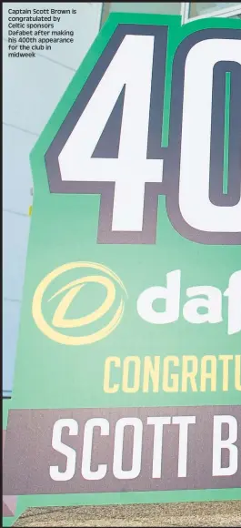  ??  ?? Captain Scott Brown is congratula­ted by Celtic sponsors Dafabet after making his 400th appearance for the club in midweek