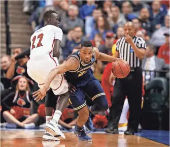  ??  ?? Zak Irvin, right, and Michigan ousted Louisville, putting three Big Ten teams in the Sweet 16. BRIAN SPURLOCK, USA TODAY SPORTS