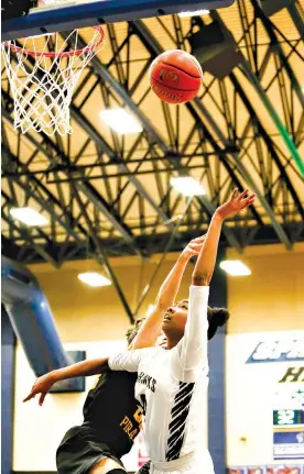  ?? Staff photo by Hunt Mercier ?? ■ Pleasant Grove's Shanequa Henry goes in for a layup under pressure from a Crandall defender Friday at Spring Hill High School in Longview, Texas.