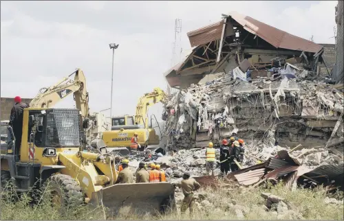  ??  ?? Rescuers at work among the rubble after an eight-story building collapsed in Nairobi, Kenya. Ten people are believed to be missing.