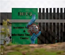  ?? AP ?? NEW ISOLATION CENTRE: A coronaviru­s statue stands as workers give final touches to a newly built isolation centre in the suburbs of Islamabad on Tuesday. —