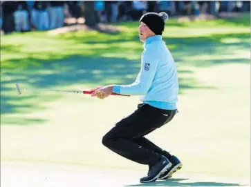  ?? Harry How Getty Images ?? A BUNDLED-UP Matt Kuchar reacts to a missed putt for par on the first hole during the second round of the Masters. Wind and cold made scoring conditions difficult during the early part of the round.