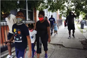  ?? JESSIE WARDARSKI — THE ASSOCIATED PRESS ?? St. Francis Xavier School students and their families walk together Aug. 6 in Newark, after discussing the Catholic school’s permanent closure announced the previous week by the Archdioces­e of Newark. Nationwide, more than 140 Catholic schools will not reopen in the fall.