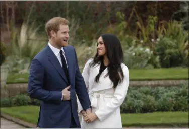  ?? MATT DUNHAM — THE ASSOCIATED PRESS FILE ?? Britain’s Prince Harry and his fiancee Meghan Markle pose for photograph­ers in the grounds of Kensington Palace in London, following the announceme­nt of their engagement. Speculatio­n is mounting over who will be invited to the royal wedding of Prince...