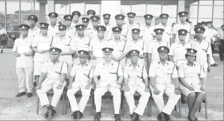  ??  ?? Acting Commission­er of Police David Ramnarine (seated third, from left) and other senior officers of the police force are flanked by the graduating ranks of the Junior Officer’s Course No.29
