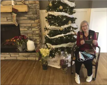  ?? ANDREW WELSH-HUGGINS — THE ASSOCIATED PRESS ?? Miriam Looker, 95, displays one of the 1,700 masks she’s made since the beginning of the coronaviru­s epidemic using her quilting skills, on Dec. 21, 2020, in Marysville, Ohio. The only break Looker has taken from her 10-mask-a-day-routine came in November when came down with COVID-19 herself, which she said left her exhausted and needing a lot of naps. Looker is no stranger to using material to help save lives: during World War II she tested parachutes at Wright Field— now Wright Patterson Air Force Base—in Dayton.