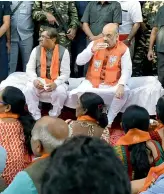  ?? — PTI ?? BJP national president Amit Shah along with party leaders and workers listen to Prime Minster Narendra Modi’s ‘Mann Ki Baat’ over tea, in Ahmedabad on Sunday.