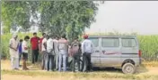  ?? AP PHOTO ?? Villagers gather near the crime scene in a field near Jewar, Greater n Noida, on Thursday.