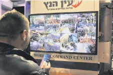  ?? ?? A man stands in front of a monitor showing surveillan­ce camera feeds in Tel Aviv during a protest against controvers­ial government plans to give lawmakers more control of the judicial system.