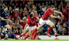  ?? AP ?? Wales wing George North races in to score during his team’s unconvinci­ng win over Scotland in Cardiff.