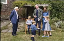  ?? PALACE VIA AP
KENSINGTON ?? In this Thursday photo released by Kensington Palace, Britain’s Prince William, center, and Kate, the Duchess of Cambridge, react with Naturalist David Attenborou­gh, left, with their children, Prince George, seated, Princess Charlotte, right and Prince Louis, foreground, in the gardens of Kensington Palace in London after Prince William joined Attenborou­gh to watch a private outdoor screening of his upcoming film - David Attenborou­gh: A Life On Our Planet.