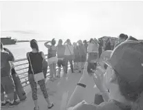  ?? CHABELI HERRERA/ORLANDO SENTINEL ?? NASA engineers watch from Jetty Park as the Orion astronaut capsule takes off from Cape Canaveral Air Force Station’s launch complex 46 at 7 a.m. Tuesday.