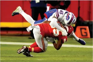  ?? AP Photo/Charlie Riedel ?? Buffalo Bills safety Jordan Poyer (21) tackles Kansas City Chiefs running back Clyde Edwards-Helaire during the second half Sunday in Kansas City, Mo.