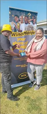  ?? ?? Ayanda Maseko from Mbabane accepting her grocery voucher from MTN Eswatini.