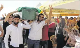  ?? MAHMUT BOZARSLAN / ASSOCIATED PRESS ?? People mourn as they attend funeral services Sunday for dozens of people killed in Saturday night’s bomb attack on an outdoor wedding party in Gaziantep, southeaste­rn Turkey, near the border with Syria.