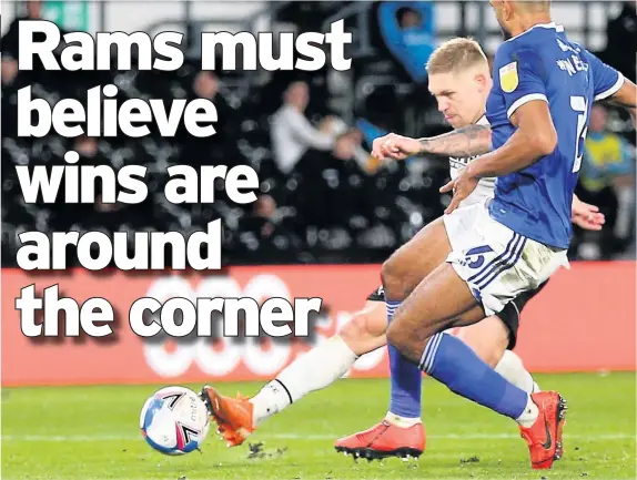  ??  ?? Martyn Waghorn (back) has a shot on goal during the Championsh­ip match against Cardiff City in midweek at Pride Park.