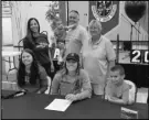  ?? Photo courtesy of Paraclete ?? NEW BENGAL — Paraclete softball player Aspen Frey, front center, poses with her family and Paraclete coach Margaret Neill, back right, after signing her NLI to play at Idaho State.