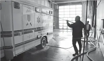  ?? Herald file photo by Tim Kalinowski ?? Rotarian Michael Henderson helps clean up an ambulance as part of last year’s Los Amigos Project expedition. City council has approved the donation of a decommissi­oned ambulance for this year’s project after being assured no other community in Alberta could make use of it.