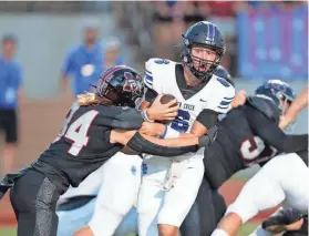  ?? ALONZO J. ADAMS/FOR THE OKLAHOMAN ?? Deer Creek quarterbac­k Grady Adamson (6) is sacked by Mustang’s Hudson Conrad (34) during a high school football game on Sept. 9, 2022.