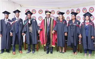  ?? ?? President Mnangagwa poses with students who graduated with the Chancellor’s Awards during the Manicaland State University of Applied Sciences graduation ceremony in Mutare yesterday. — Picture: Tinai Nyadzayo.
