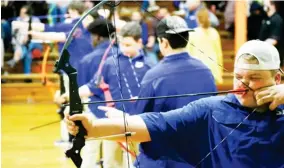  ??  ?? Members of the Starkville Academy archery team shoot during one of their rounds against Starkville High School on Tuesday night. (Photo by Chris Mcmillen, SDN)