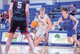  ?? Steven Eckhoff ?? Unity Christian’s Austin Wilkerson drives down the lane between two defenders.