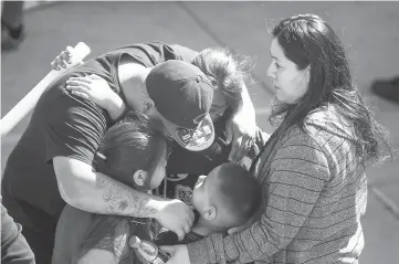  ??  ?? North Park Elementary School students and parents reunited at Cajon High School after the shooting at their school in San Bernardino, California. — AFP photo