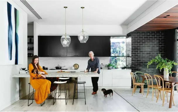  ??  ?? KITCHEN DINING Alice and Danny opted for a solid slab of granite for their bench, which has a bronzed mirror base, and teamed it with Tim Webber Design Wrap stools. The Lindsay Adelman Terrarium pendant lights were shipped from New York and the painting is by Agneta Ekholm. The customised Corbusier end chairs are from
Thonet and positioned around. “We asked for it to be narrower and therefore more intimate,” says Alice. A pantry/laundry is tucked away just o the kitchen. COURTYARD Low garden furniture works well in the small but perfectly formed outdoor space. The Kettal Maia outdoor sofa and chairs and Vieques co ee table are from Mobilia. The steel doors are custom made.